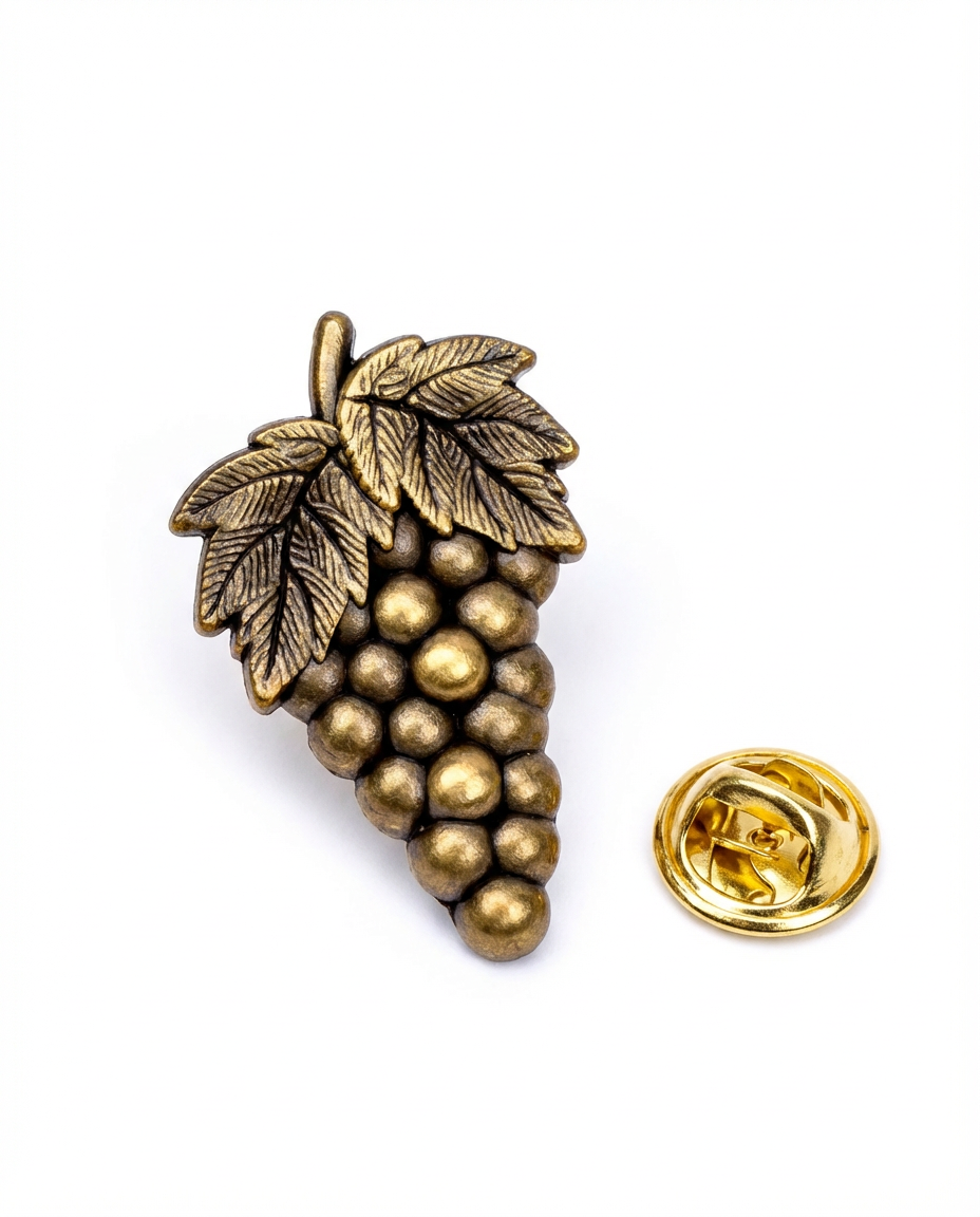 Reverse of an antique gold sommelier pin showing the butterfly clutch backing used on lapel pins
